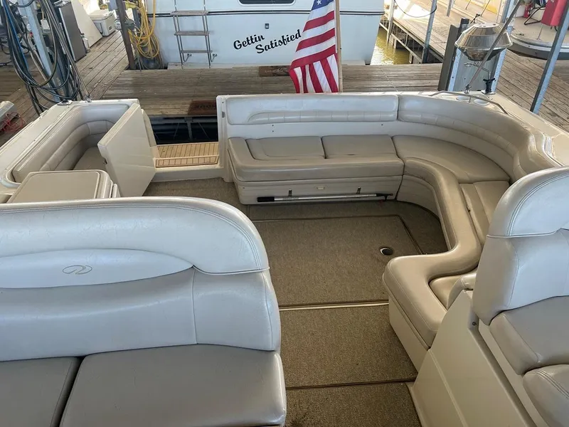 Slide: The Image of 1999 Regal 402 boat interior with beige seating and American flag. - 25