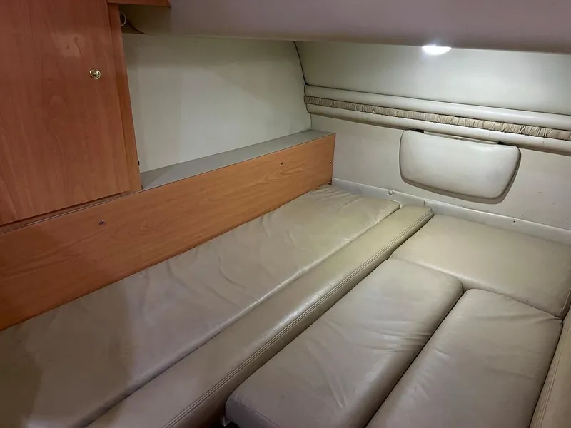 Slide: The Image of Interior cabin of a 1999 Regal 402 boat with beige leather seating. - 34