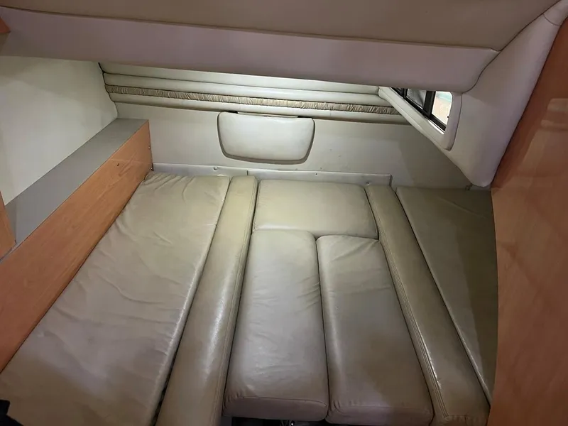 Slide: The Image of 1999 Regal 402 interior cabin with beige leather seating and wood accents. - 35