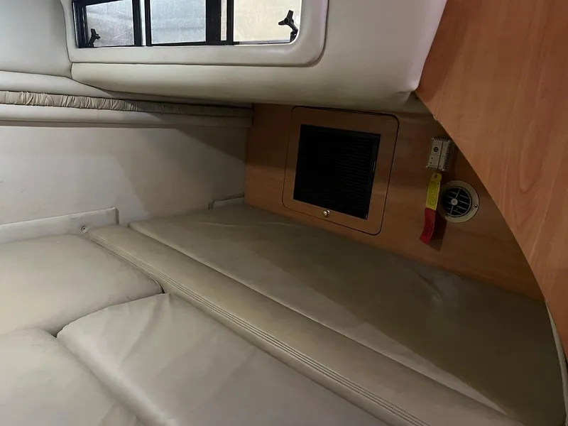 Slide: The Image of Interior cabin of a 1999 Regal 402 boat with beige seating and wood paneling. - 36