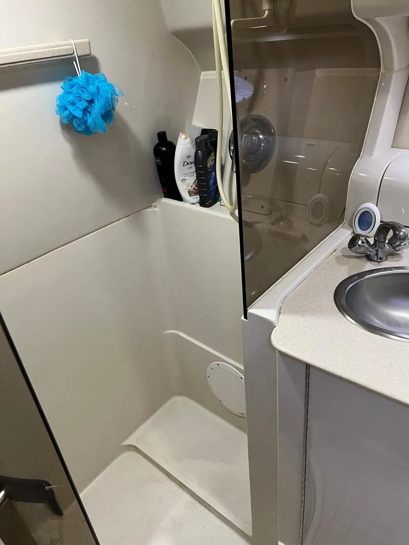 Slide: The Image of 1999 Regal 402 boat bathroom with shower, sink, and toiletries. - 40