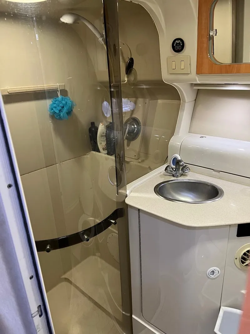 Slide: The Image of 1999 Regal 402 boat bathroom with shower, sink, and storage. - 41