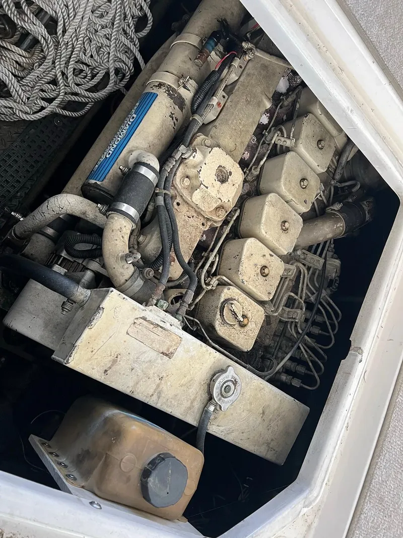 Slide: The Image of Engine compartment of a 1999 Regal 402 boat, showcasing mechanical components and wiring. - 44