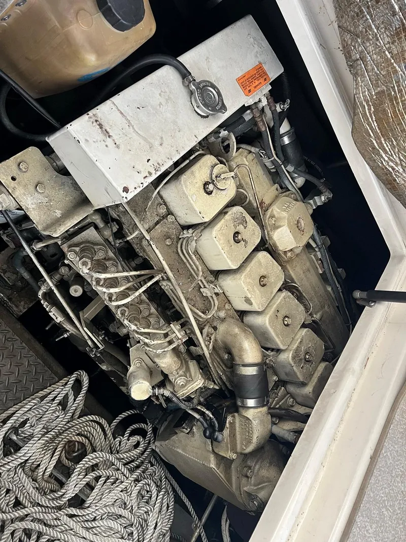 Slide: The Image of Engine compartment of a 1999 Regal 402 boat with visible ropes and mechanical components. - 45