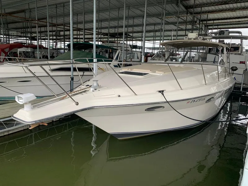 Slide: The Image of 1999 Regal 402 boat docked in a covered marina, side view. - 9