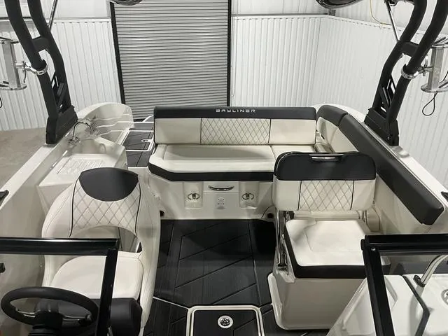 Slide: The Image of 2023 Bayliner DX2250 boat interior with white seating and black accents. - 10