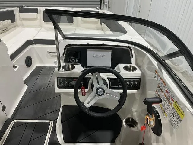 Slide: The Image of 2023 Bayliner DX2250 boat cockpit with steering wheel and control panel. - 13