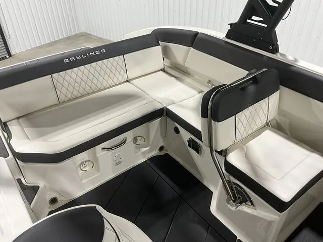 Slide: The Image of 2023 Bayliner DX2250 boat interior with white and black seating. - 16