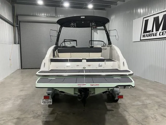 Slide: The Image of 2023 Bayliner DX2250 boat in a showroom, rear view with swim platform. - 3