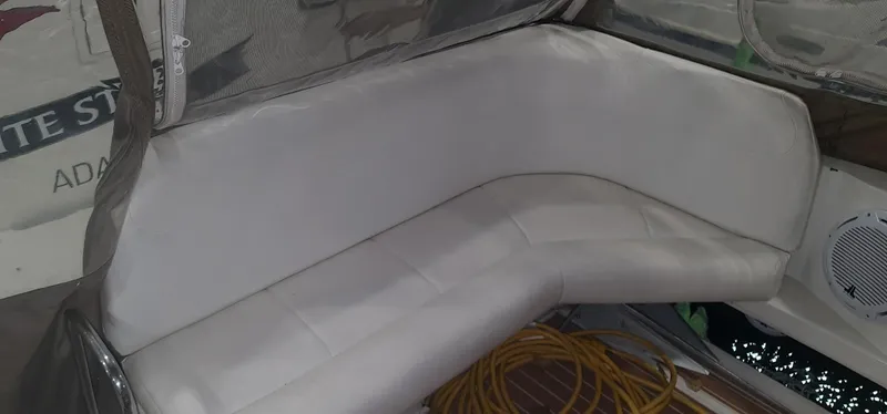 Slide: The Image of Interior of 1995 Carver 528 Montego with white seating area. - 7