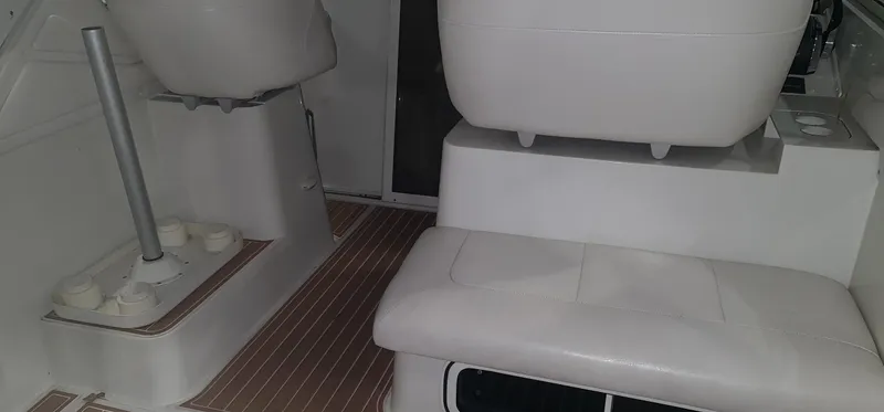Slide: The Image of Interior of a 1995 Carver 528 Montego boat with white seating. - 6