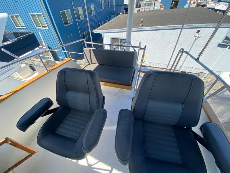 Slide: The Image of 1981 Rough Water 37 Sedan boat with black seating on deck. - 10