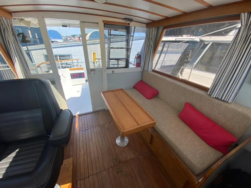 Slide: The Image of Interior of 1981 Rough Water 37 Sedan with seating, table, and large windows. - 13