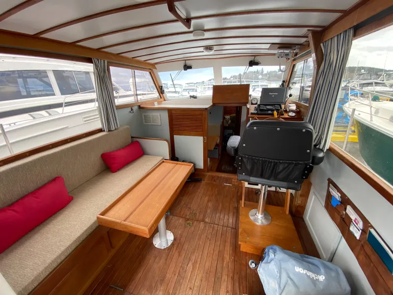 Slide: The Image of 1981 Rough Water 37 Sedan boat interior with wooden flooring, seating area, and helm station. - 14