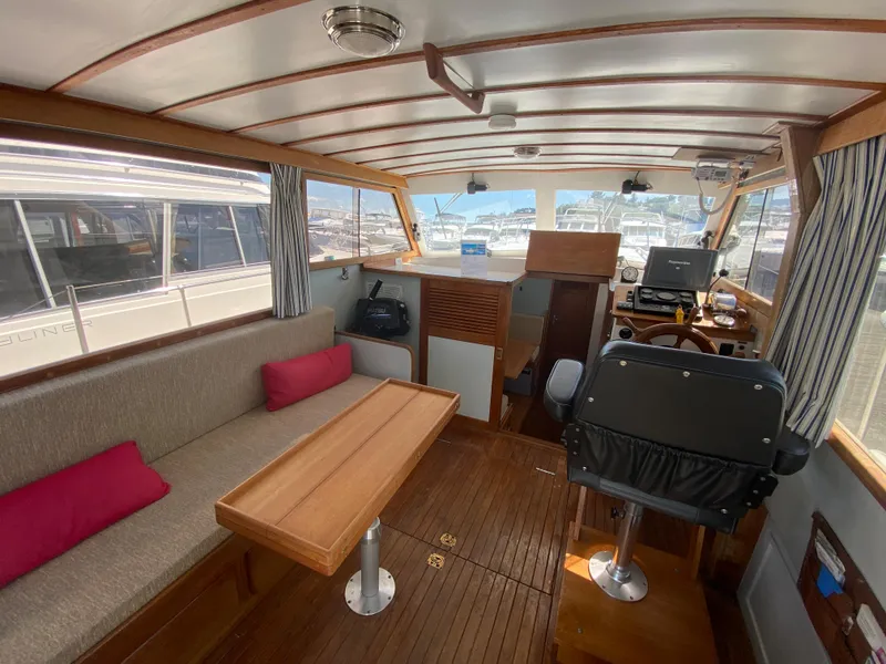 Slide: The Image of Interior of 1981 Rough Water 37 Sedan boat with seating, table, and helm station. - 16
