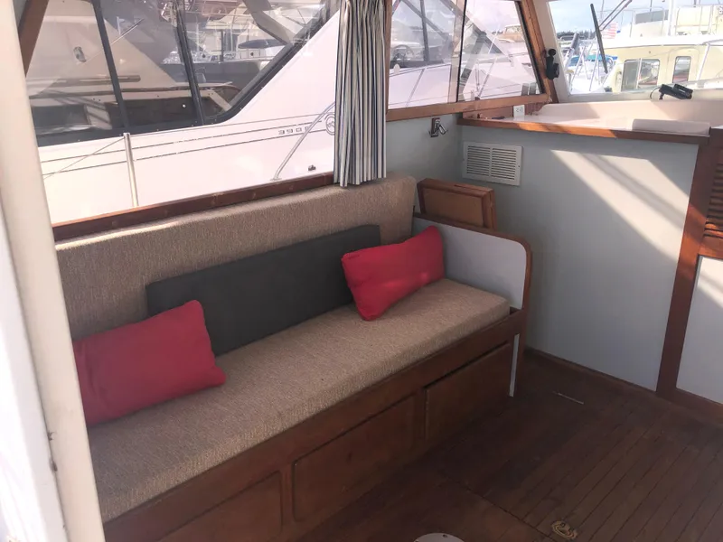 Slide: The Image of Interior of 1981 Rough Water 37 Sedan with cushioned seating and wooden accents. - 18