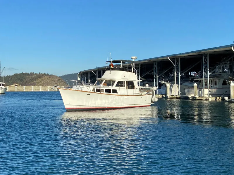 Slide: The Image of 1981 Rough Water 37 Sedan boat docked in a marina under clear blue skies. - 2