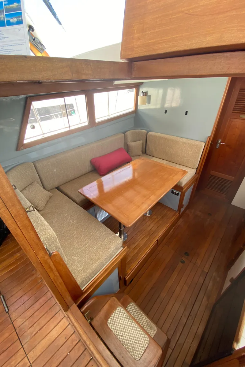 Slide: The Image of Interior of 1981 Rough Water 37 Sedan with wooden table and cushioned seating. - 28