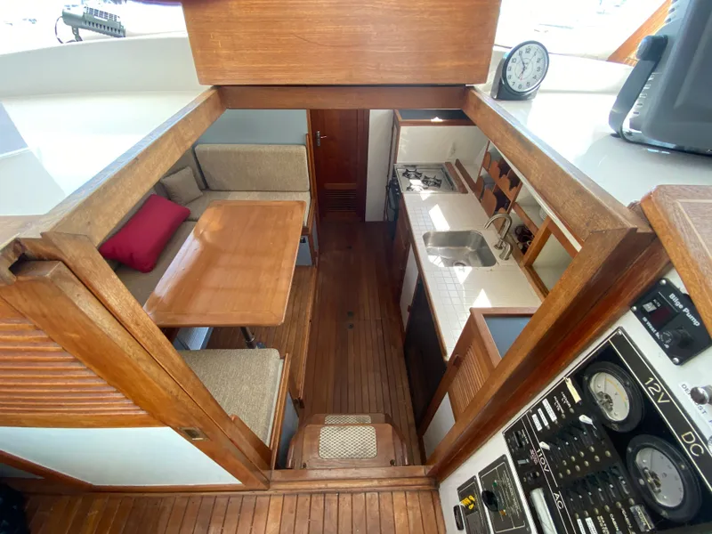 Slide: The Image of Interior of 1981 Rough Water 37 Sedan with dining area and kitchen. - 29