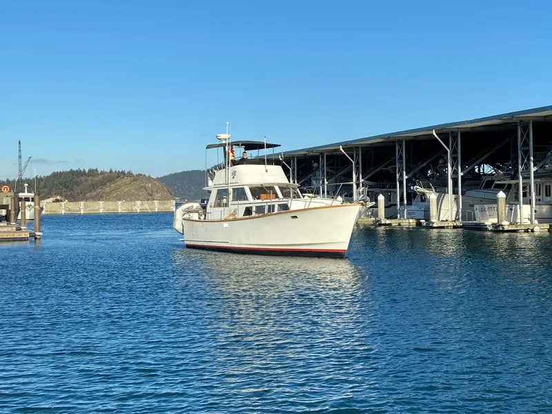 Slide: The Image of 1981 Rough Water 37 Sedan boat docked in a marina under clear blue skies. - 3