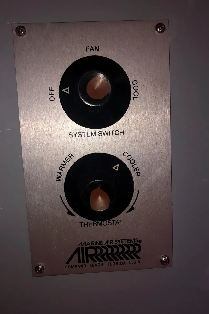 Slide: The Image of Marine air system control panel with fan and thermostat settings on a 1981 Rough Water 37 Sedan. - 35