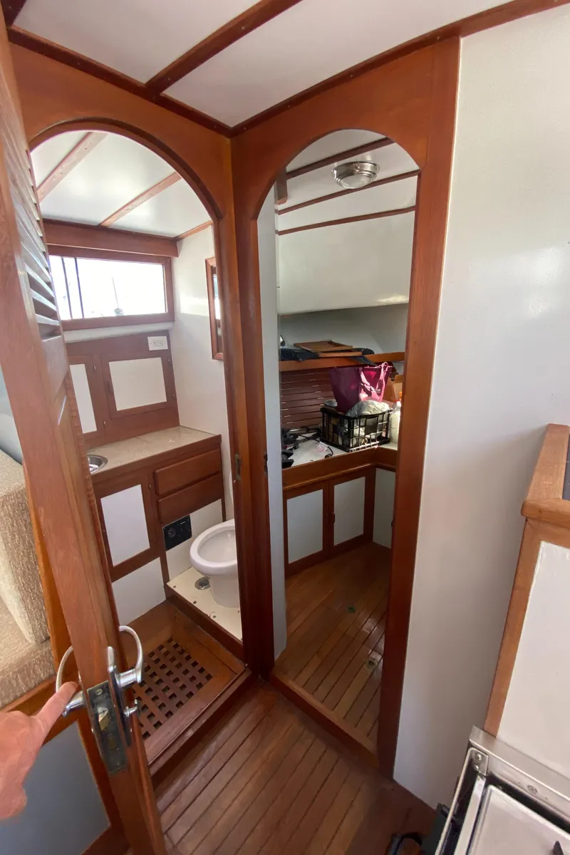 Slide: The Image of Interior of 1981 Rough Water 37 Sedan boat with wooden trim and compact bathroom. - 36