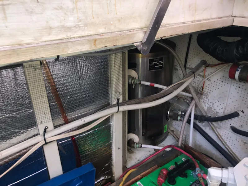 Slide: The Image of Engine room of 1981 Rough Water 37 Sedan with visible wiring and equipment. - 44
