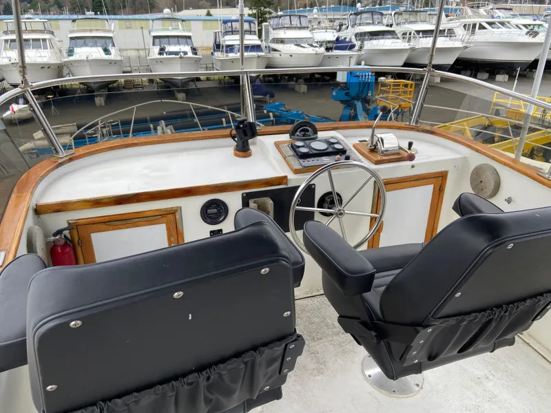 Slide: The Image of 1981 Rough Water 37 Sedan boat helm with dual seats and steering wheel. - 8