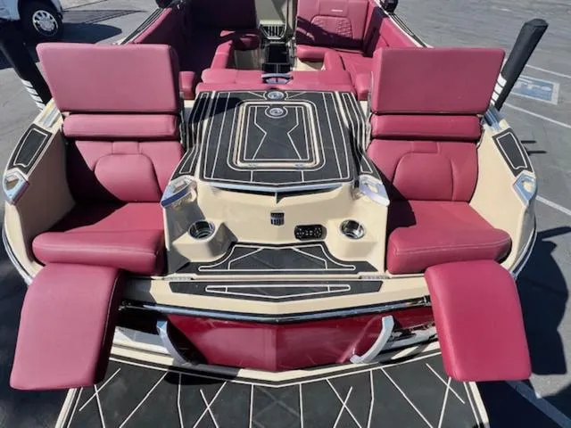 Slide: The Image of 2022 MasterCraft X26 boat with luxurious red seating and sleek design. - 10