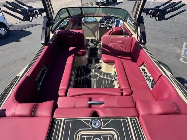 Slide: The Image of 2022 MasterCraft X26 boat with luxurious red seating and modern interior design. - 11