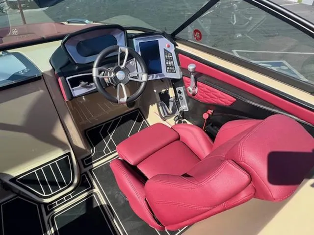 Slide: The Image of 2022 MasterCraft X26 boat interior with red leather seating and modern dashboard. - 12