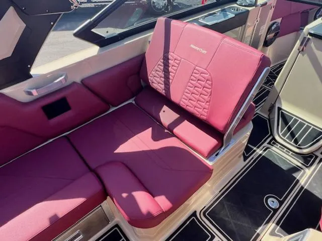 Slide: The Image of 2022 MasterCraft X26 interior with luxurious maroon seating and modern design. - 13