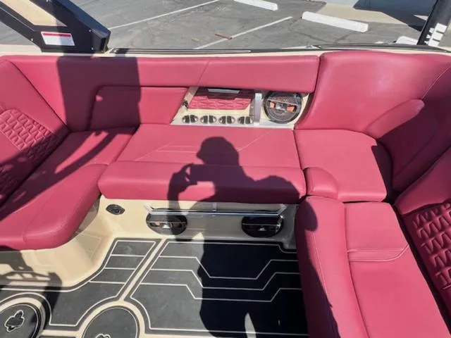 Slide: The Image of 2022 MasterCraft X26 boat interior with red seating and modern design. - 17