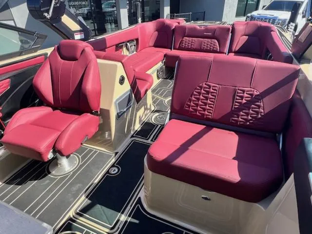 Slide: The Image of 2022 MasterCraft X26 boat interior with luxurious red seating and modern design. - 19