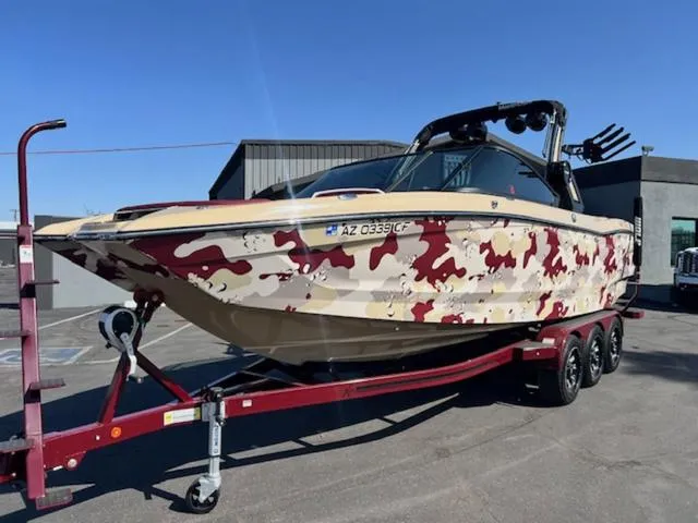Slide: The Image of 2022 MasterCraft X26 boat with camouflage design on a trailer. - 2