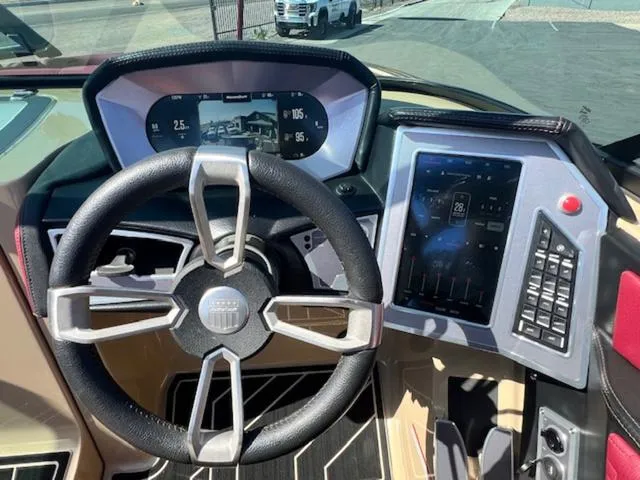 Slide: The Image of 2022 MasterCraft X26 dashboard with modern steering wheel and digital controls. - 20