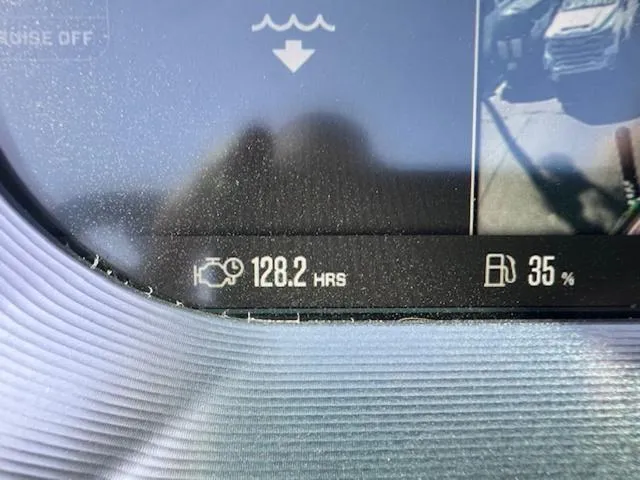 Slide: The Image of Dashboard display of a 2022 MasterCraft X26 showing 128.2 engine hours and 35% fuel level. - 21