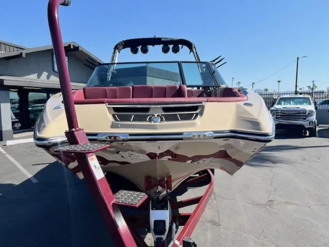 Slide: The Image of 2022 MasterCraft X26 boat on trailer, parked outdoors. - 3