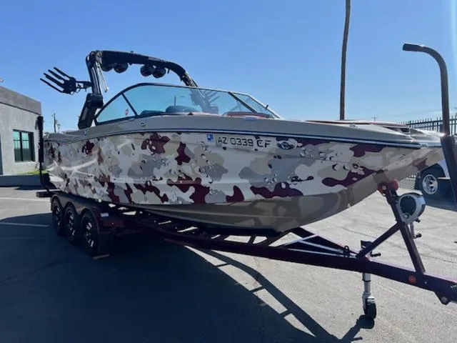 Slide: The Image of 2022 MasterCraft X26 boat with camouflage design on a trailer. - 4