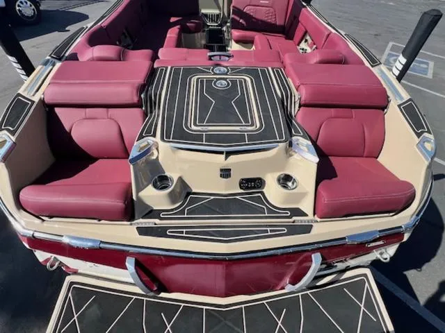 Slide: The Image of 2022 MasterCraft X26 boat with luxurious maroon seating and sleek design. - 9