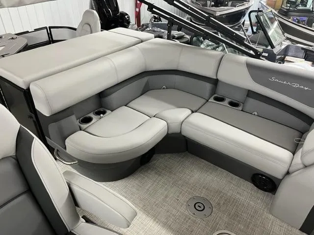 Slide: The Image of 2024 South Bay S224FCR3 pontoon boat interior with gray seating and cup holders. - 3