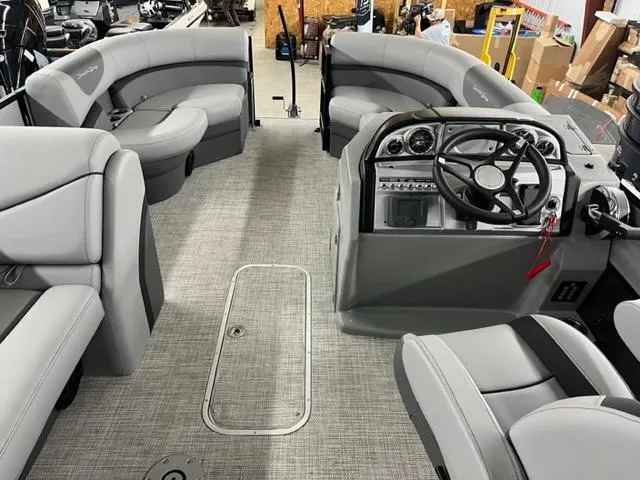 Slide: The Image of 2024 South Bay S224FCR3 pontoon boat interior with gray seating and modern dashboard. - 5