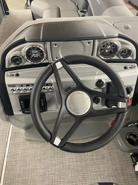 Slide: The Image of 2024 South Bay S224FCR3 boat dashboard with steering wheel and gauges. - 9