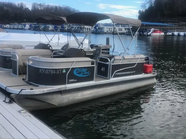 The Image of 2018 Princecraft Pontoon boat docked on a calm lake. - 1