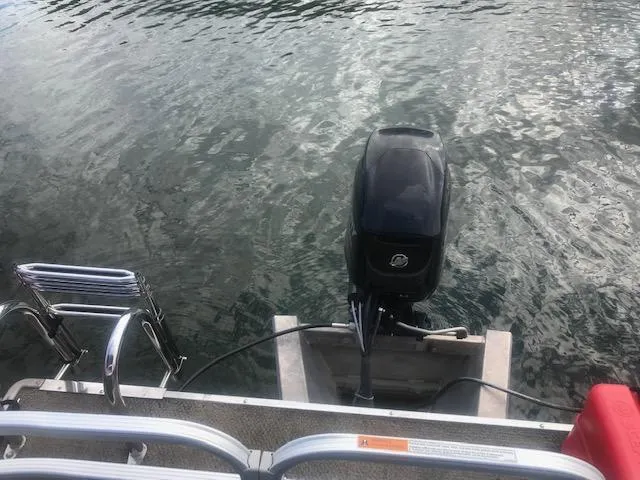 Slide: The Image of 2018 Princecraft Pontoon boat with outboard motor on water. - 5