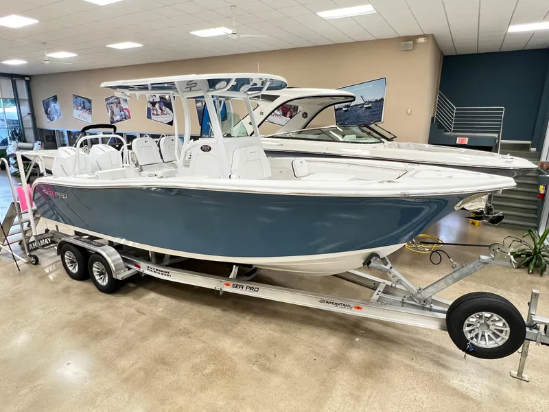 Slide: The Image of 2023 Sea Pro 259 Deep V CC boat on trailer in showroom. - 1