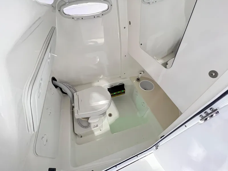 Slide: The Image of 2023 Sea Pro 259 Deep V CC boat interior bathroom with toilet and porthole. - 10