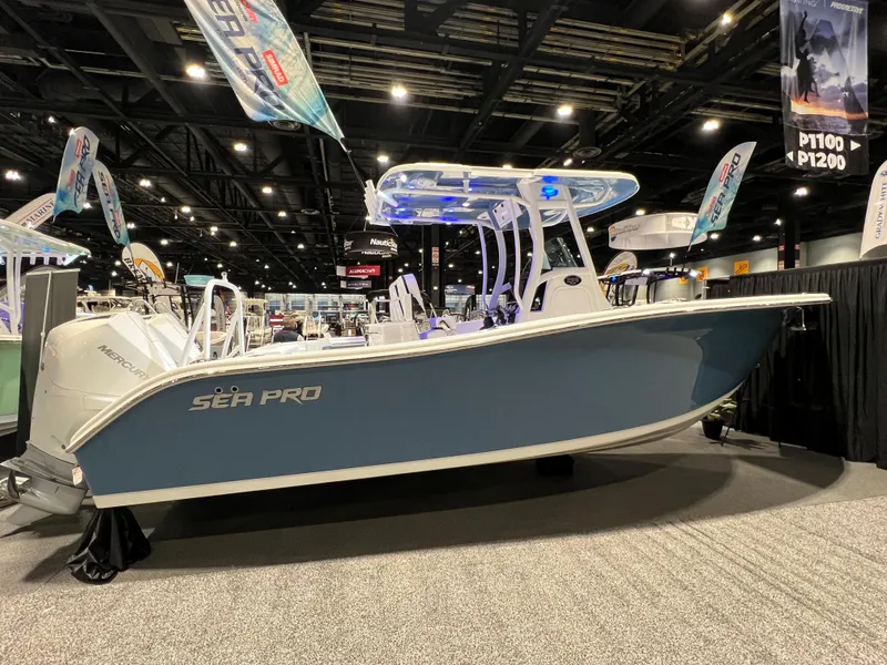 Slide: The Image of 2023 Sea Pro 259 Deep V CC boat displayed at an indoor boat show. - 13