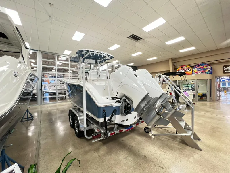 Slide: The Image of 2023 Sea Pro 259 Deep V CC boat in showroom, rear view with dual engines. - 2