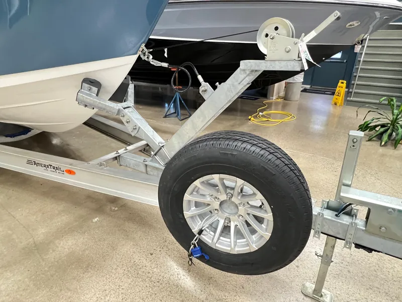 Slide: The Image of 2023 Sea Pro 259 Deep V CC on trailer, showcasing wheel and hitch details. - 4